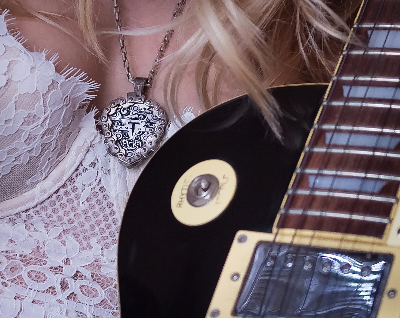 Image of model wearing Tantris Guitar Pick Holder Pendant. Photo by Frankie James.
